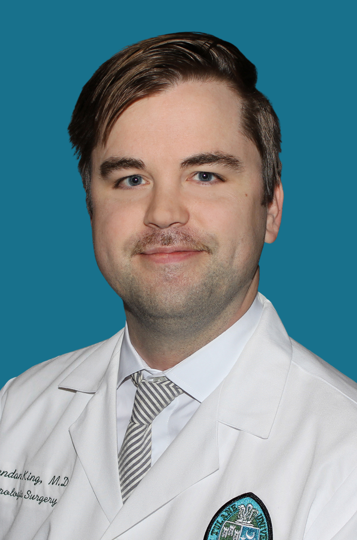 Dr. Brendon King in a white doctors coat